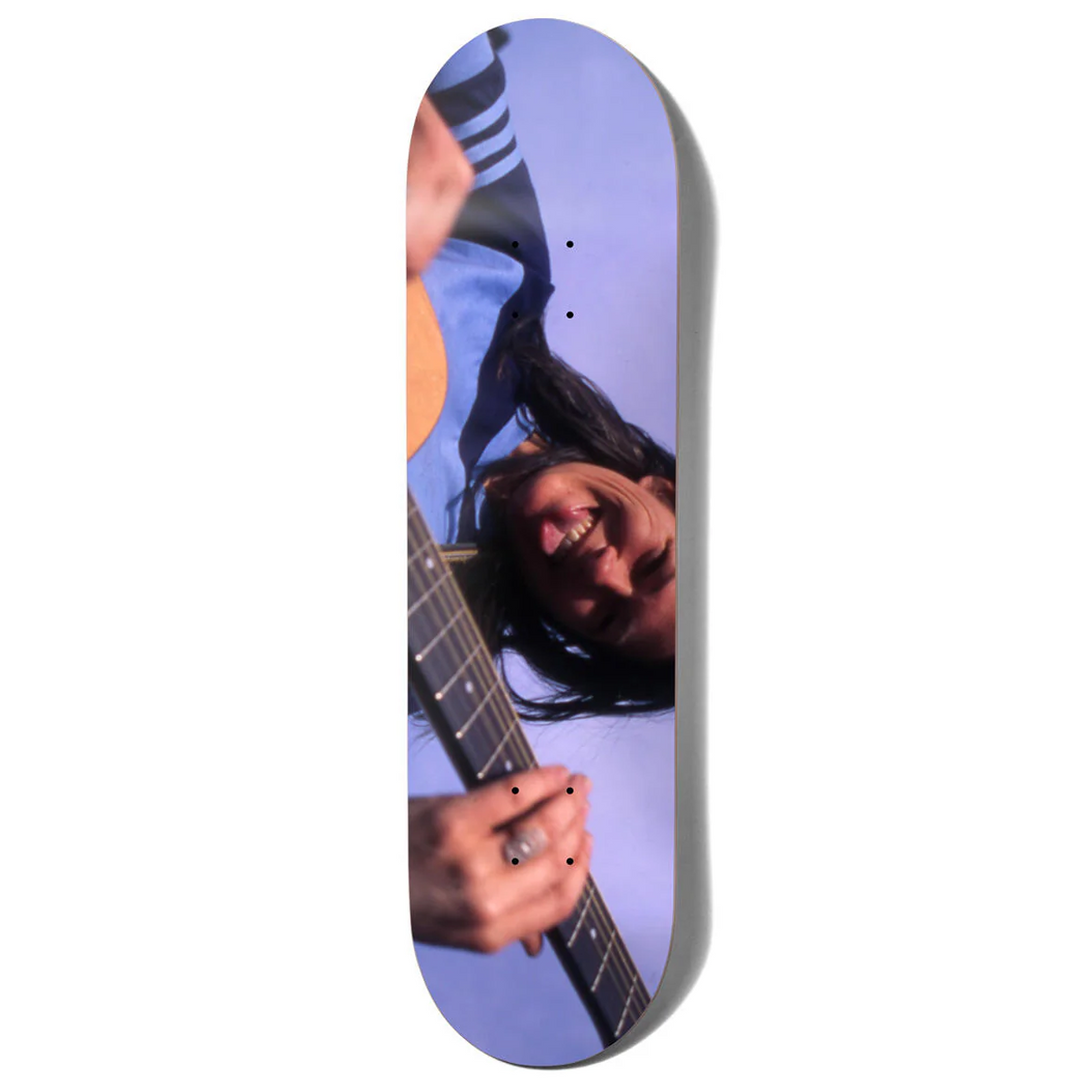 Skateboard deck with a person playing guitar on a white background