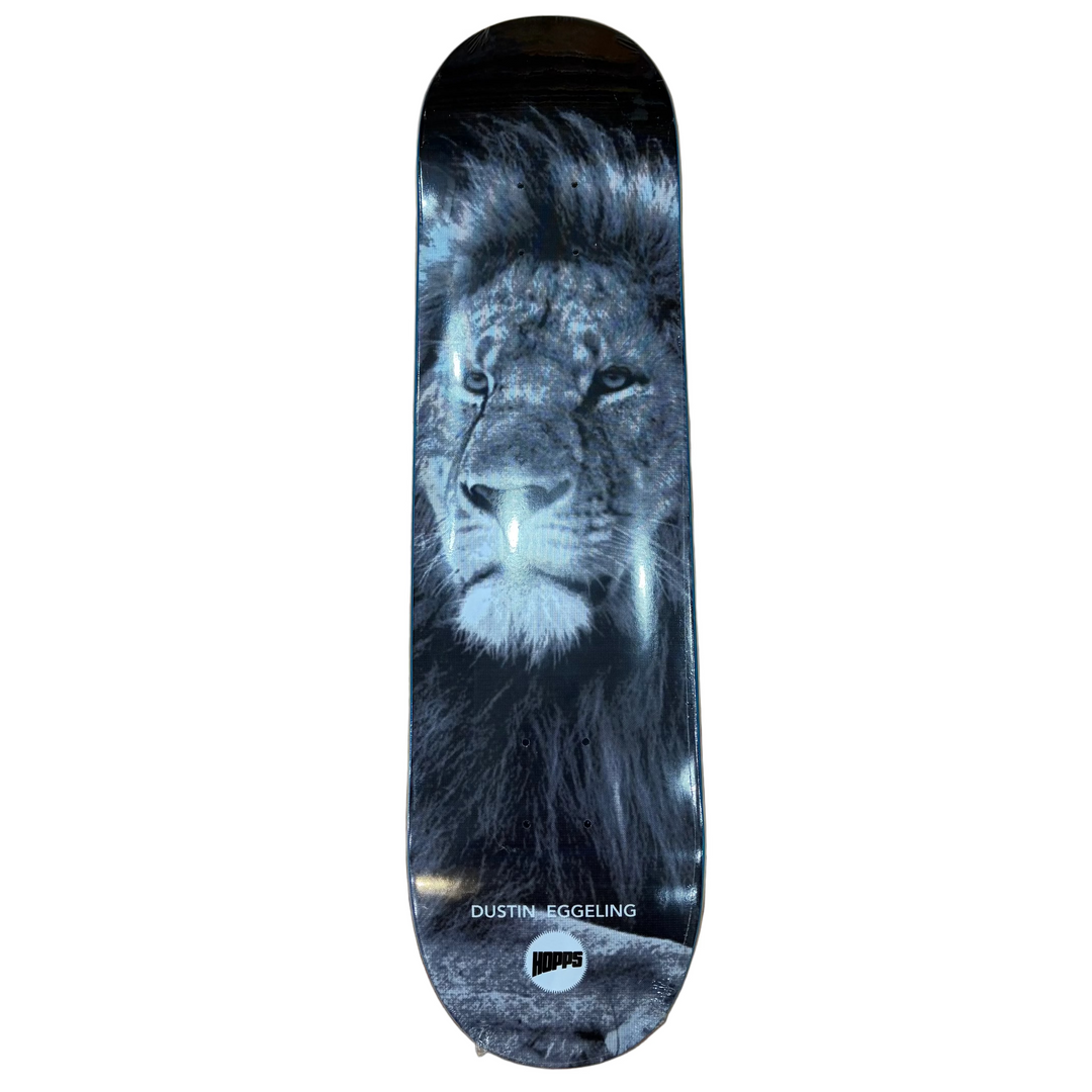 Skateboard deck with a lion design on a wooden floor