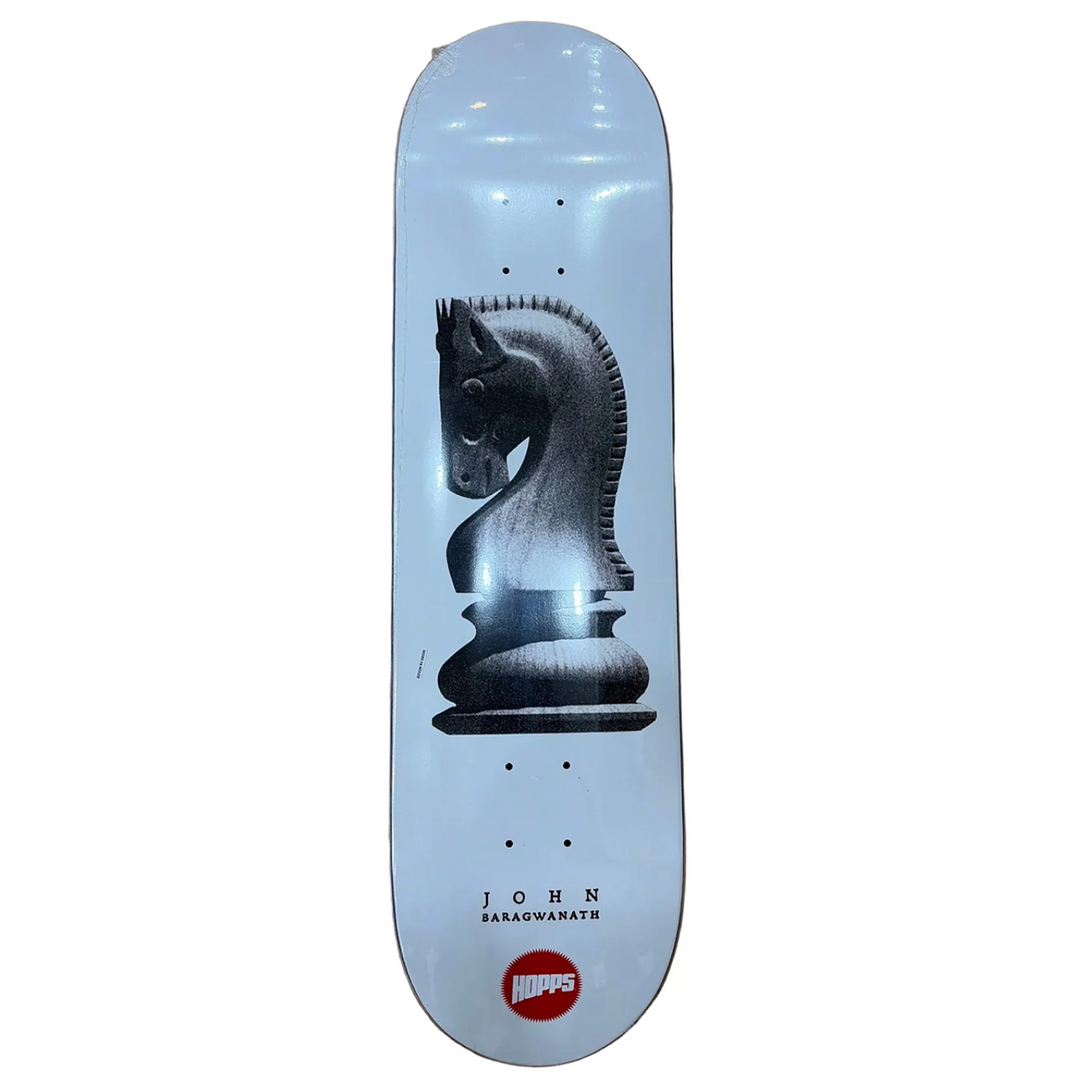 A skateboard deck featuring a large black and white chess knight graphic on a light blue background, with the text 'JOHN BARAGWARTH' and a red 'JUMPS' logo near the bottom.