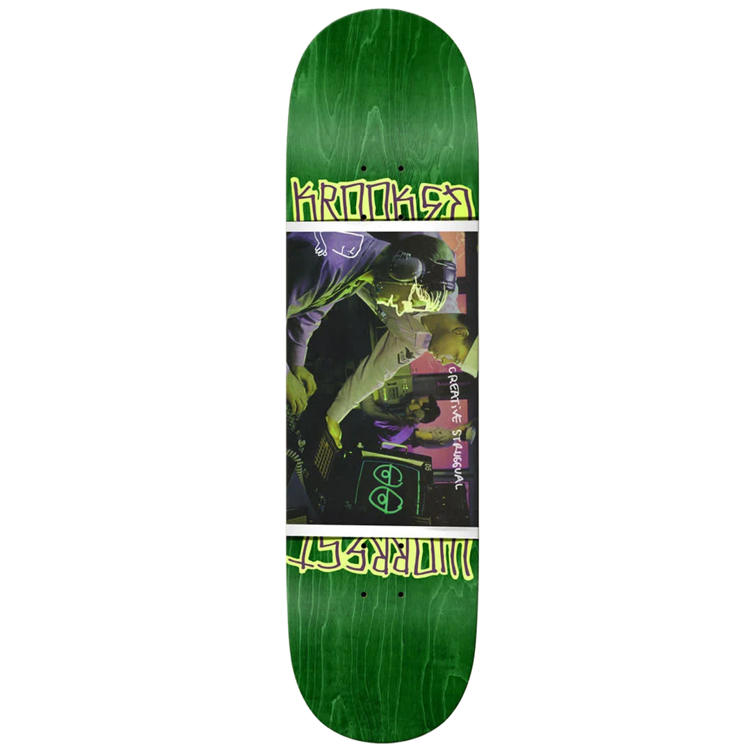 Green skateboard deck with graphic design and krooked text 