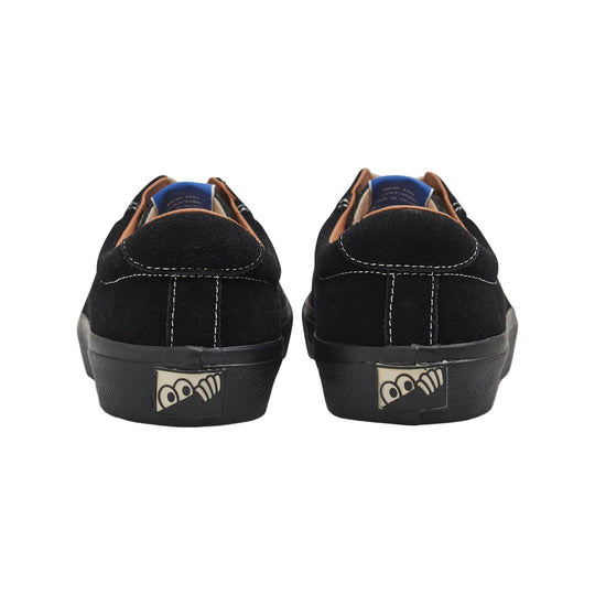 Black sneakers with a logo on the sole against a white background