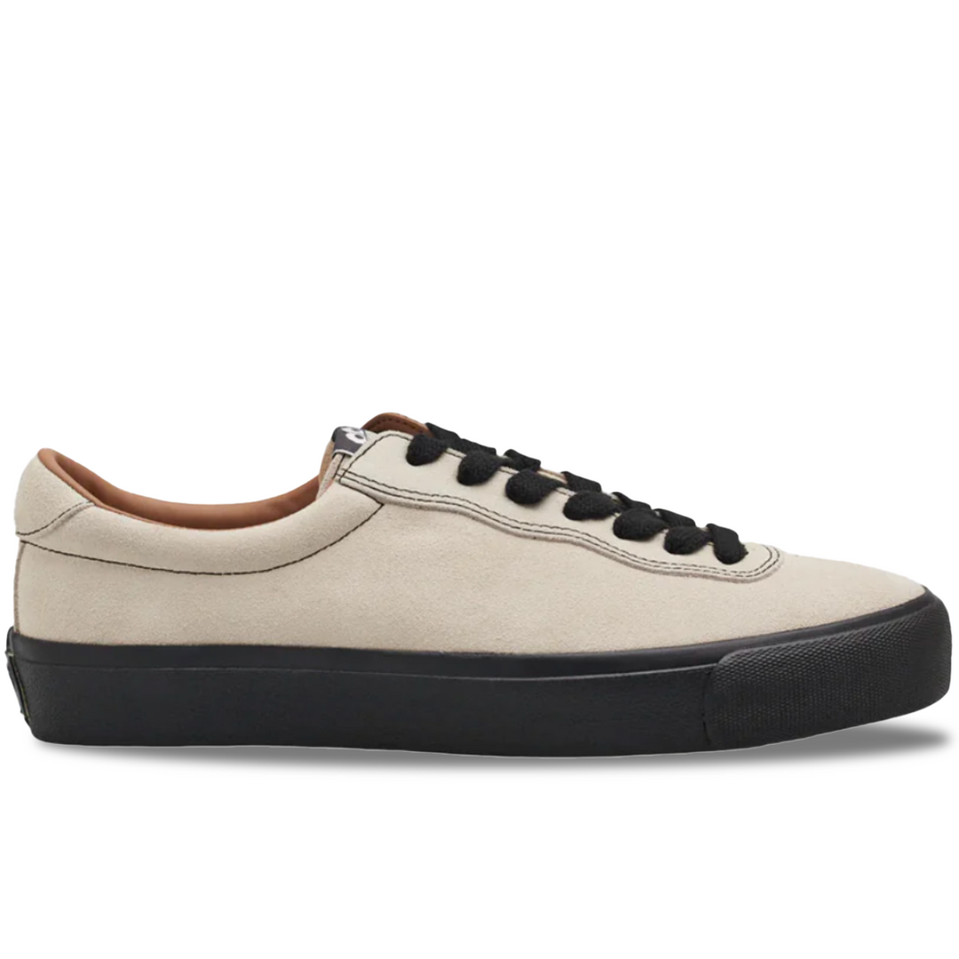 Beige sneaker with black sole on a white background