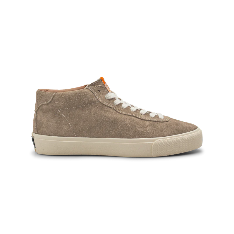 Brown suede sneaker with white laces on a white background