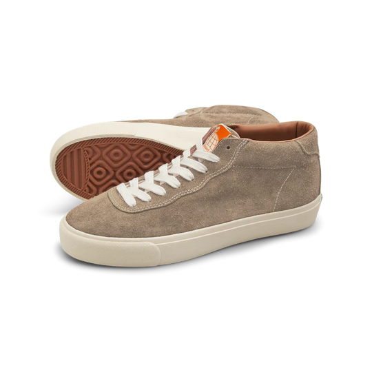 Pair of brown sneakers with white laces on a white background