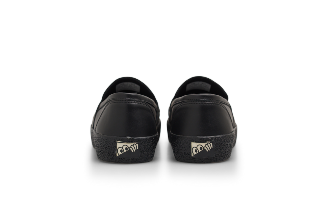 Black shoes with cartoonish eye designs on a white background