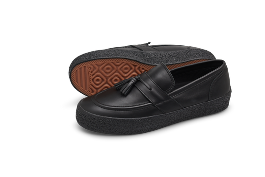 Black loafers with tassel on a white background