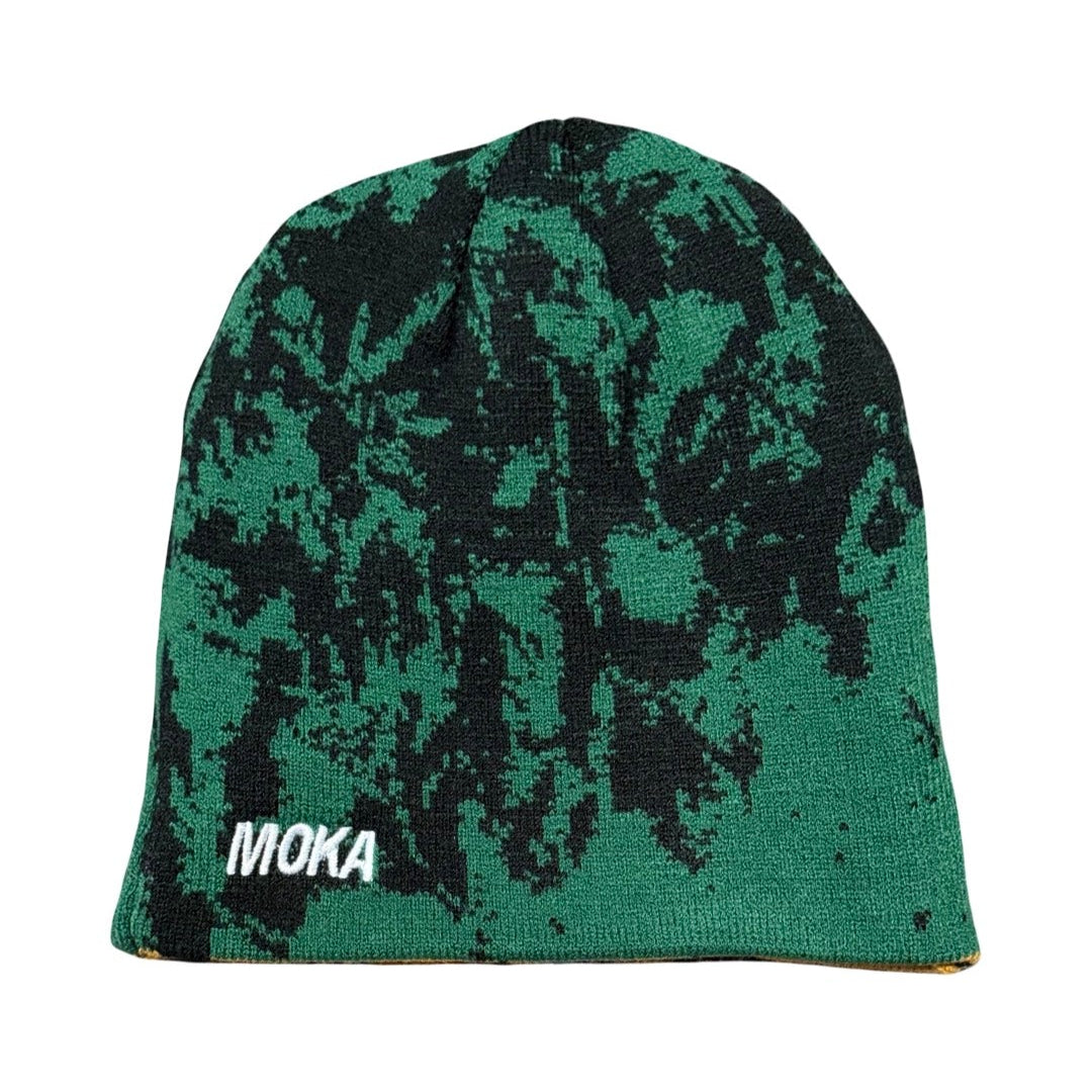 Green and black patterned beanie with 'Moka' branding on a white background