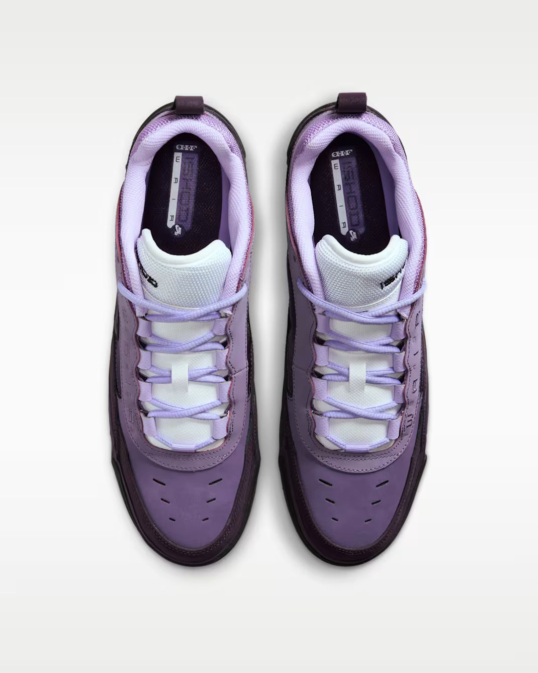 Purple and white sneakers on a light gray background