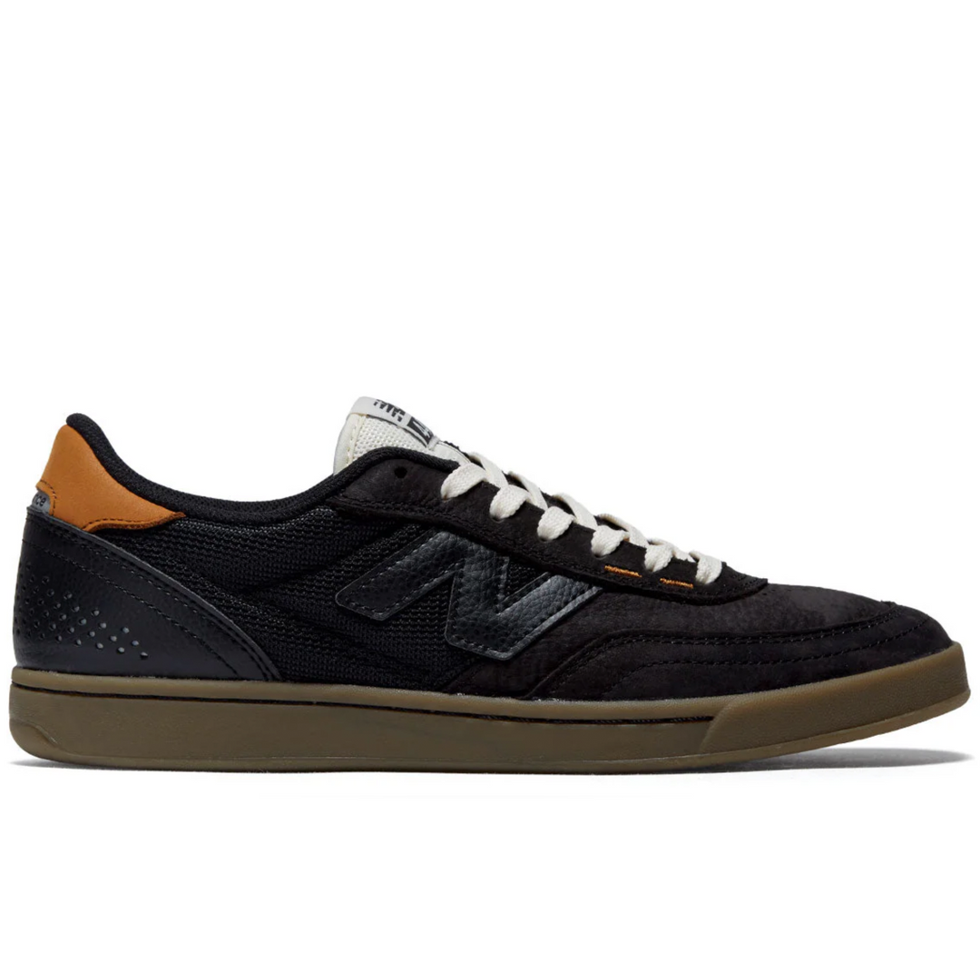 Black sneaker with brown accents on a white background