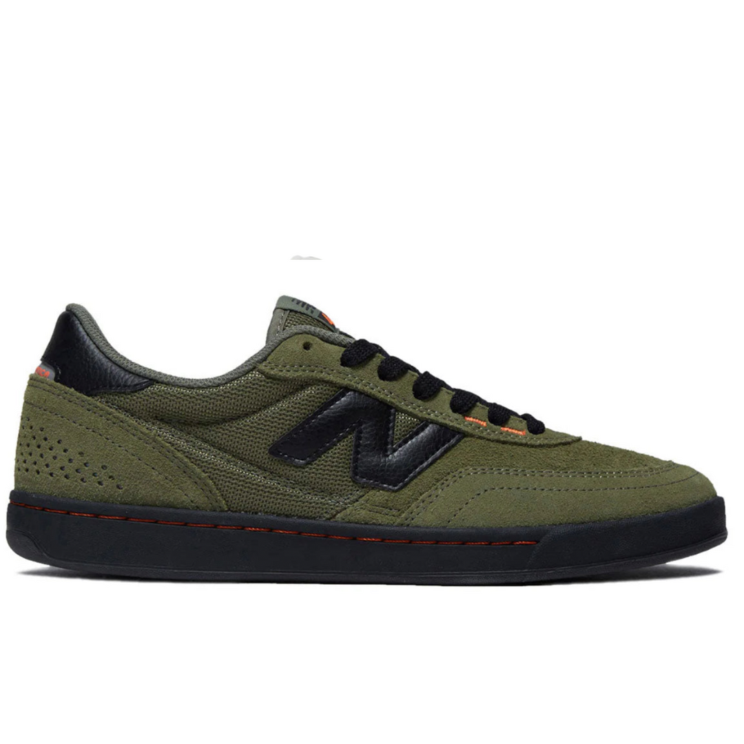 Green sneaker with black accents on a white background