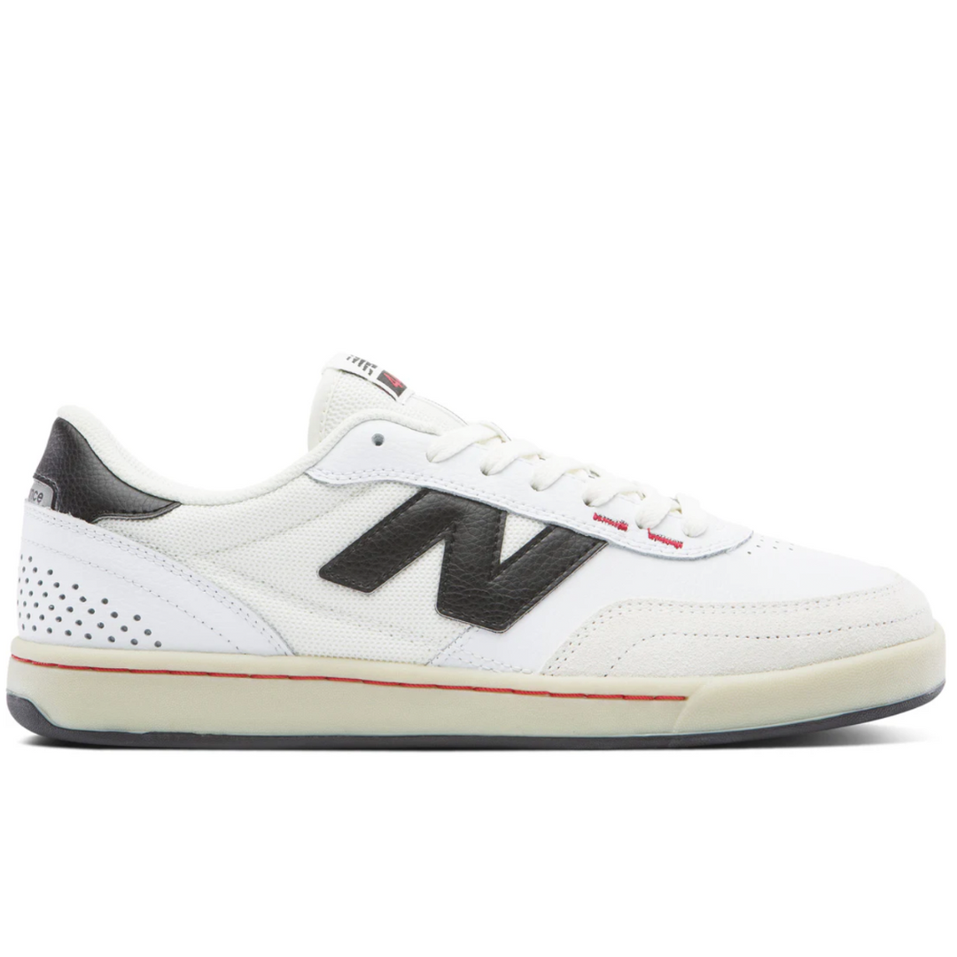 White sneaker with black logo on a white background