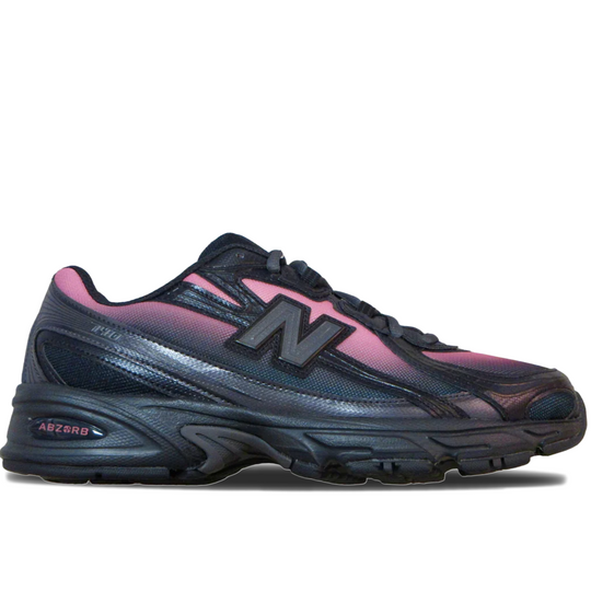 A New Balance 9060 running shoe in black and dark gray with pink accents on the collar, side overlays, and logo, shown from a side profile on a white background.