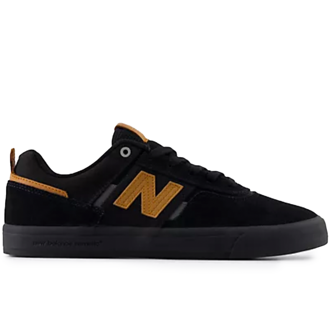 Black sneaker with a gold 'N' logo on a white background