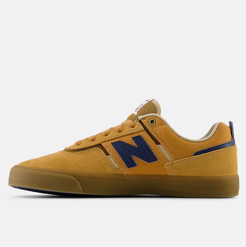 Tan sneaker with blue 'N' logo on a white background