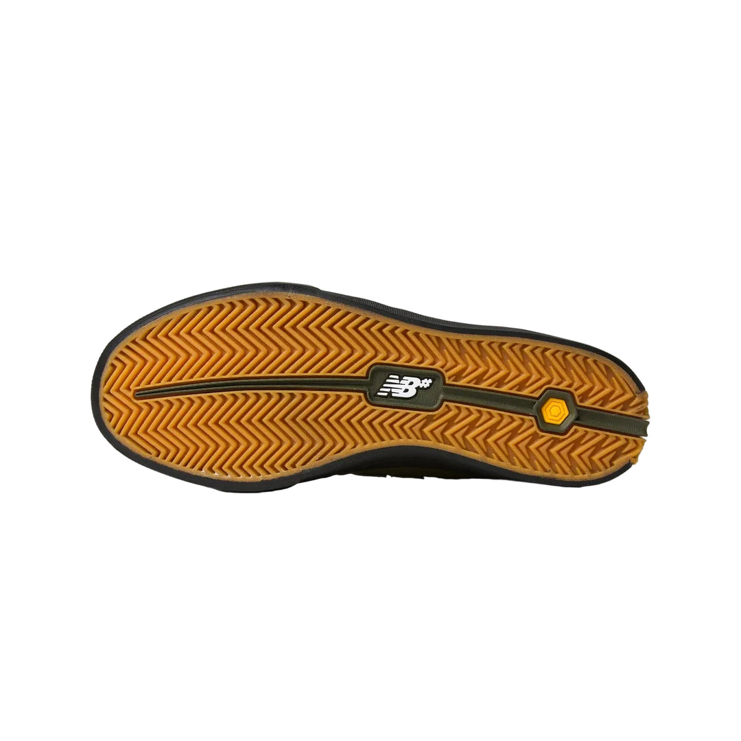 The outsole of a New Balance shoe, showing a textured orange and black tread pattern with the New Balance logo in the center.