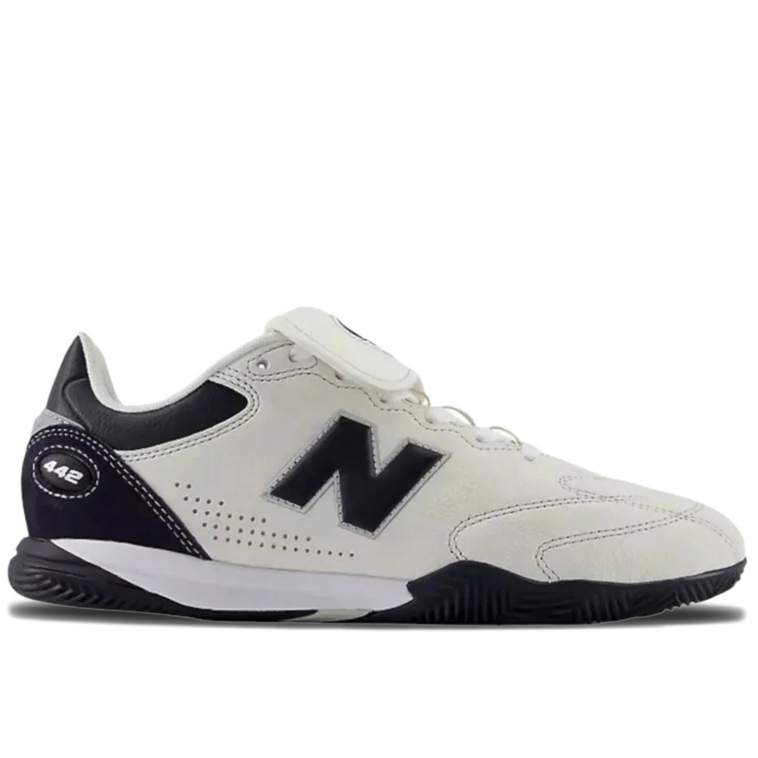 A New Balance 442 indoor soccer shoe in off-white and navy blue, shown from a side profile view on a white background.