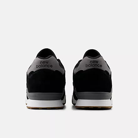 Black New Balance sneakers with visible branding on a white background