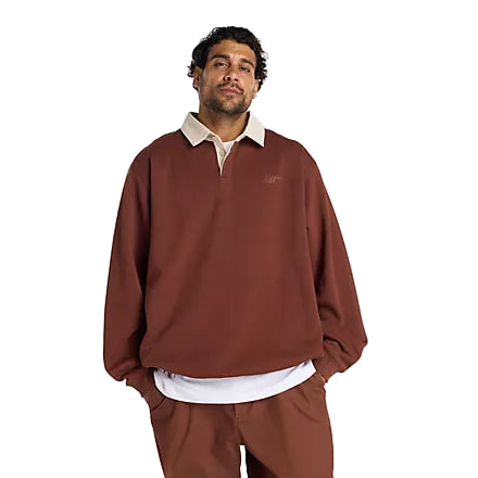 Man wearing a brown sweatshirt and pants with a white shirt underneath on a white background