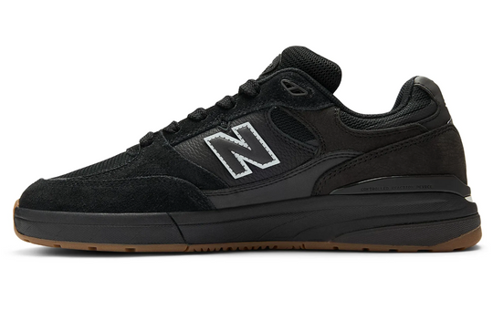 Black sneaker with reflective New Balance logo 