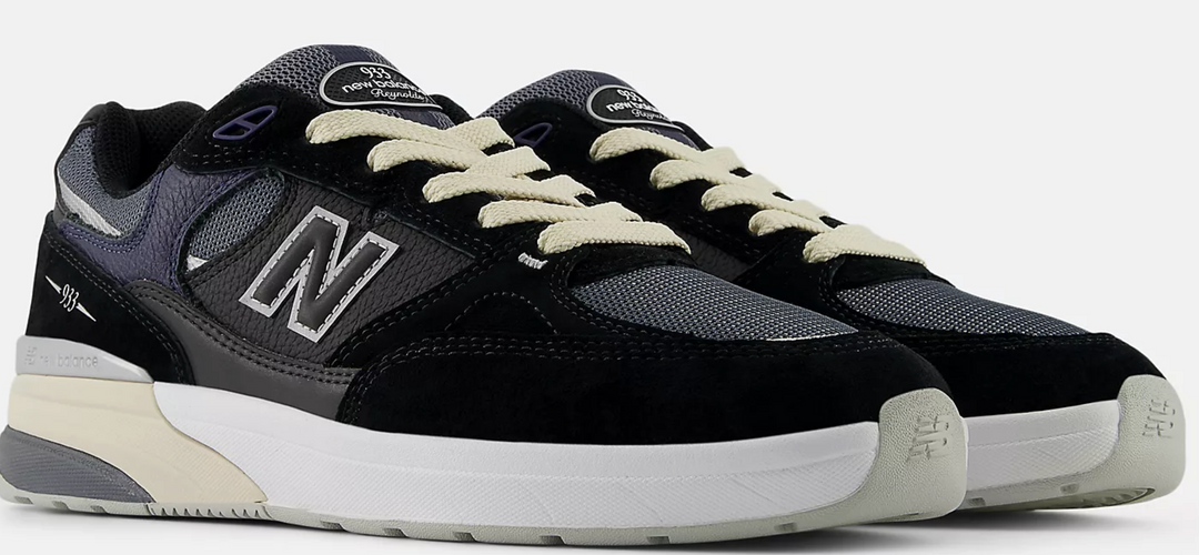 Black New Balance sneakers with blue accents snd cream laces 