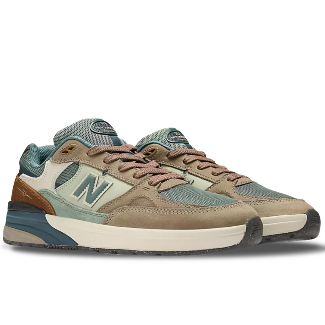 Brown and green sneakers with New Balance logo on a white background