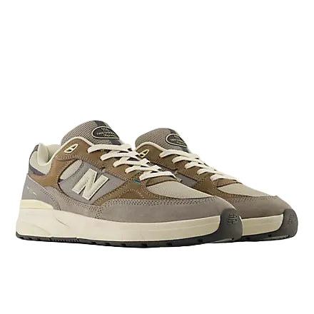 Pair of brown and gray sneakers with New Balance logo on a white background