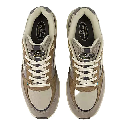 Pair of beige and brown sneakers on a white background