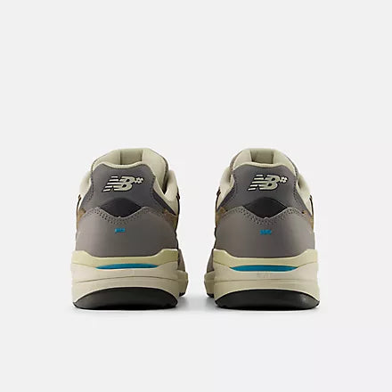 Pair of gray sneakers with a visible brand logo on a white background