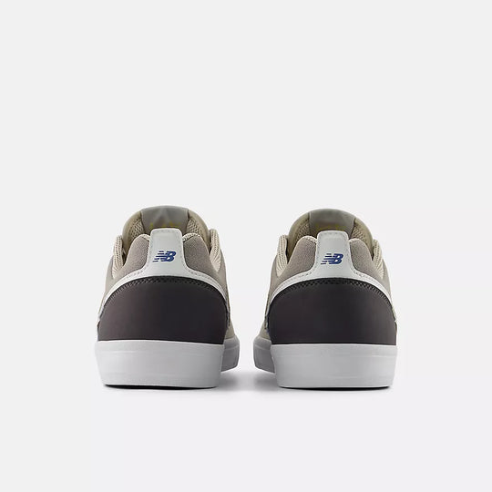 Pair of gray sneakers with a visible brand logo on a white background