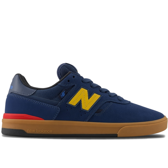 A New Balance skate shoe in navy blue suede and mesh, featuring a prominent yellow &