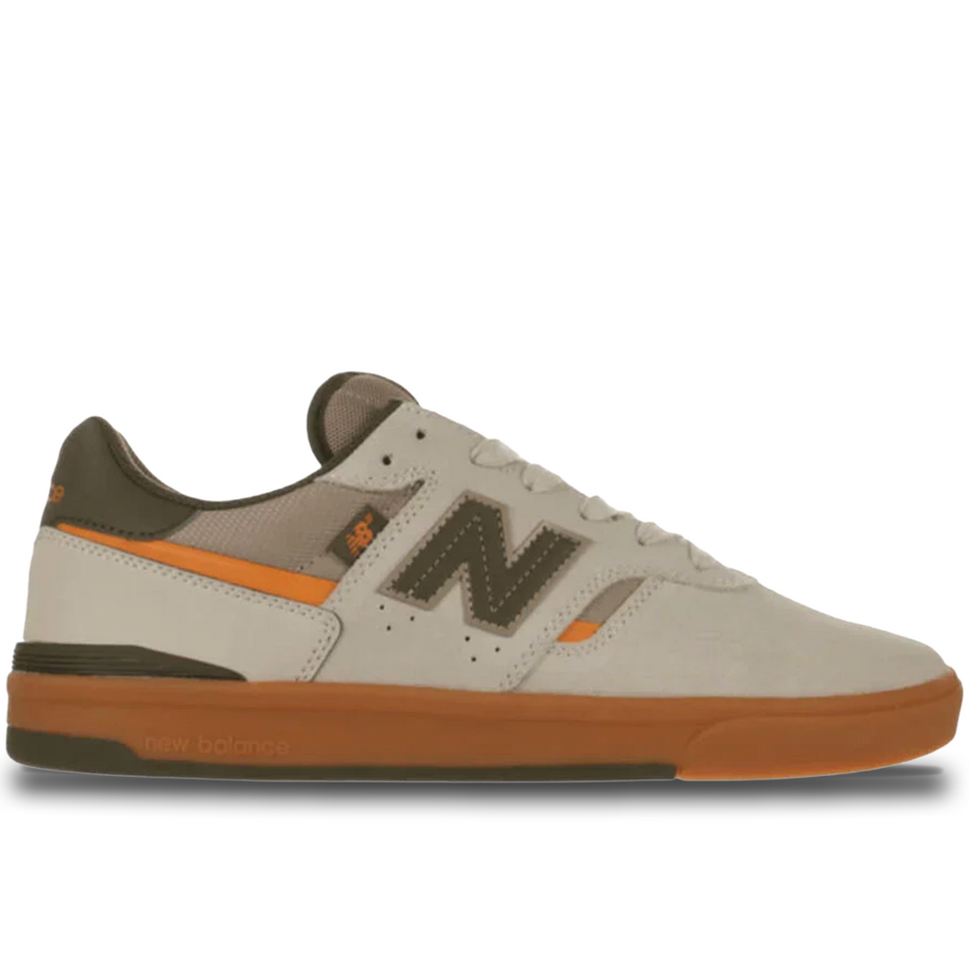 Beige sneaker with brown and orange accents on a white background