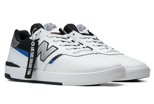 White sneaker with black and blue accents on a white background