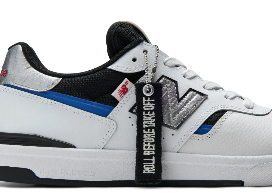 White sneaker with black and blue accents and a keychain attached, on a white background