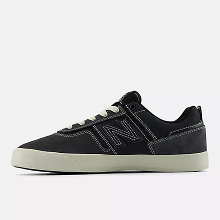 Black sneaker with white sole on a light gray background