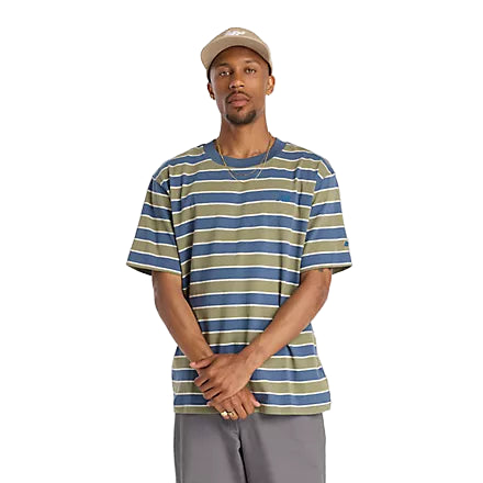 Man wearing a striped t-shirt and cap on a plain background