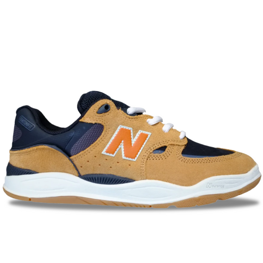 Tan and navy sneaker with orange 'N' logo on a white background