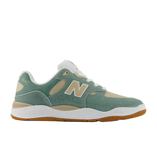Green sneaker with white sole on a white background