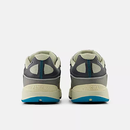 Gray athletic shoes with blue accents on a white background