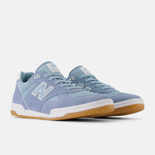 Blue sneakers with brown soles on a white background