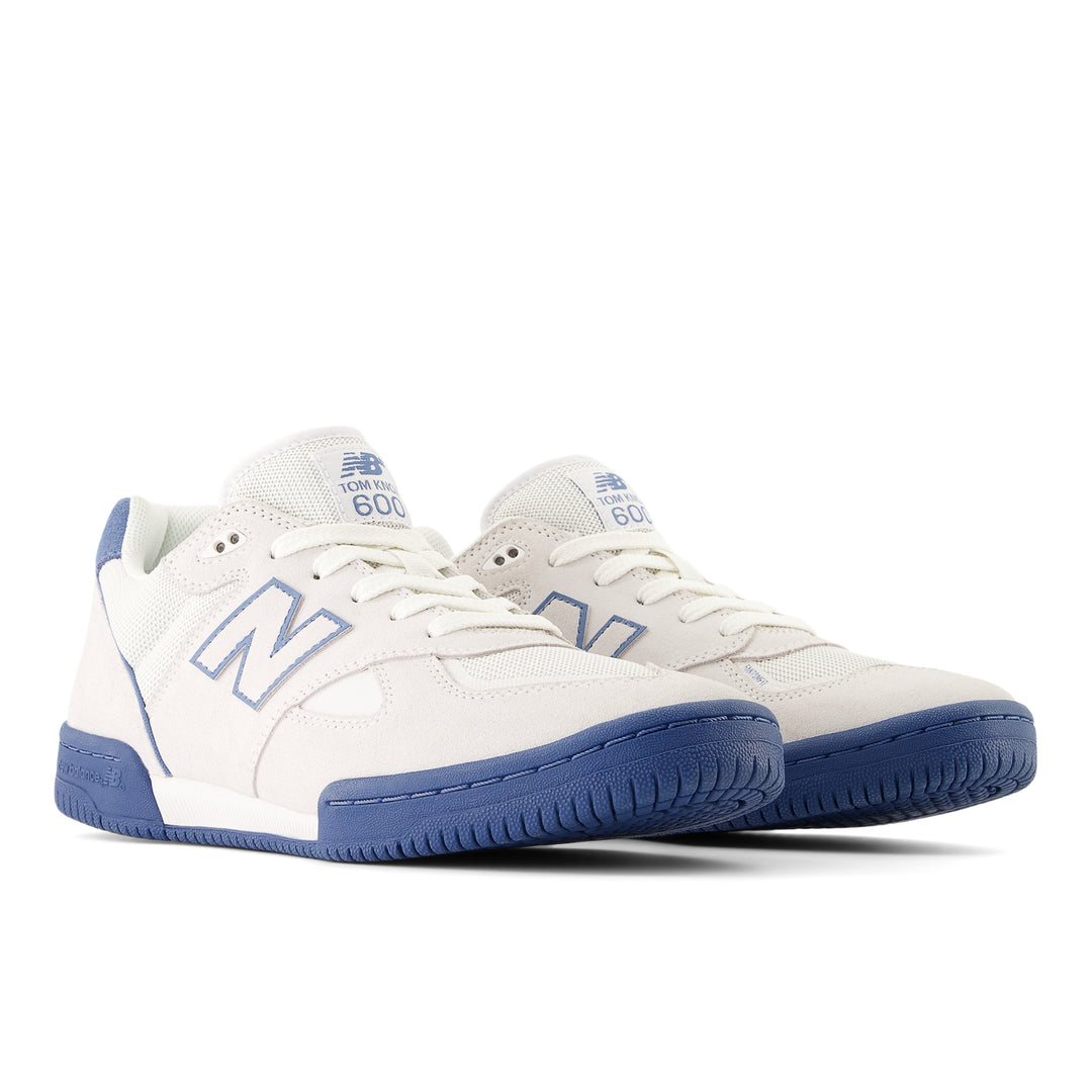 White sneakers with blue soles and accents on a white background