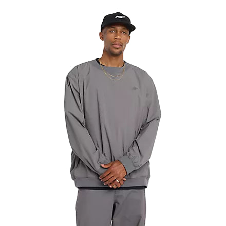 Man wearing a gray sweatshirt and pants on a white background