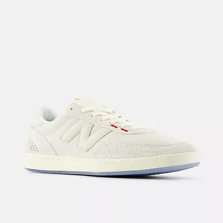 White sneaker with a red tag on a white background