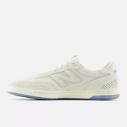 White sneaker with blue sole on a white background