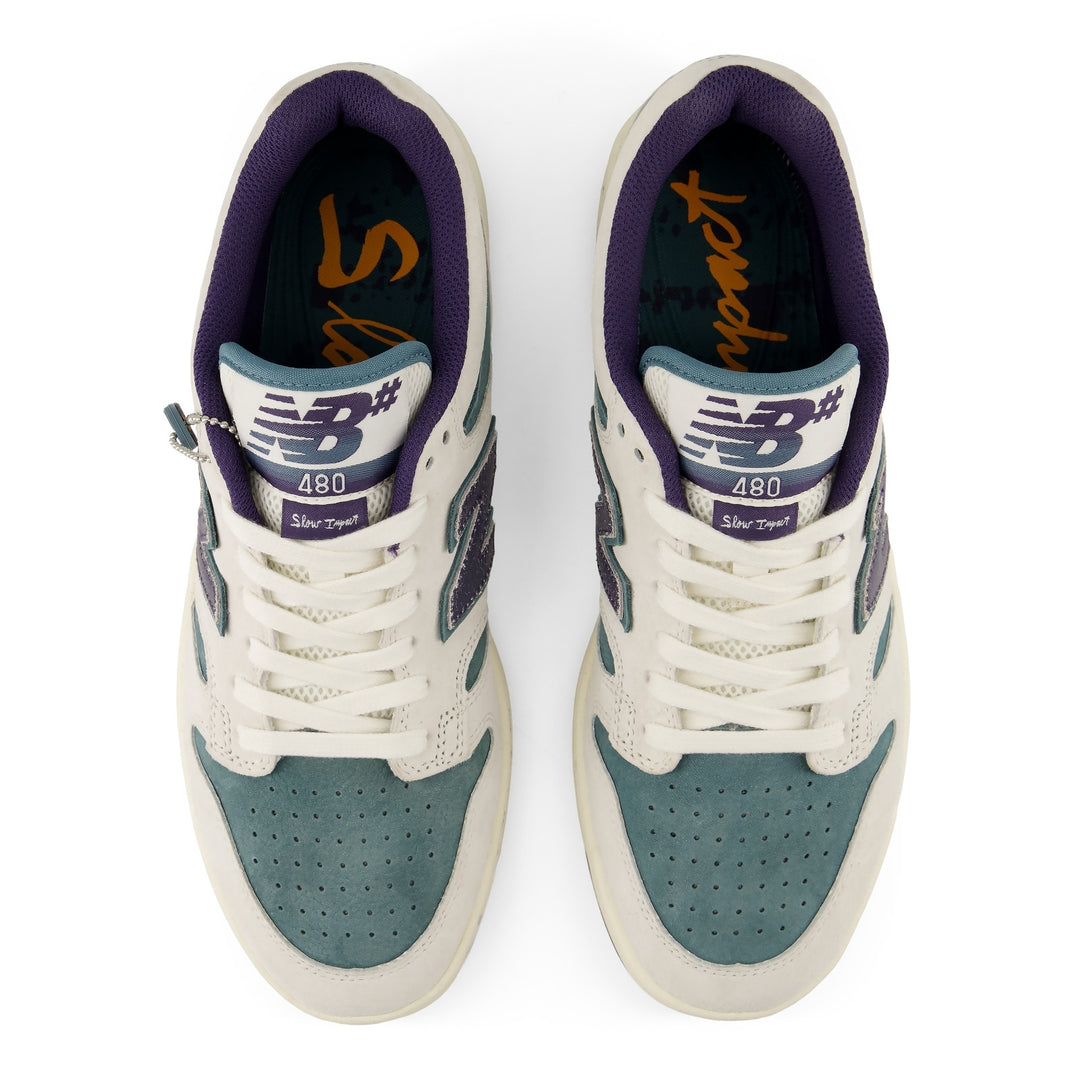 Pair of sneakers with purple and white accents on a white background