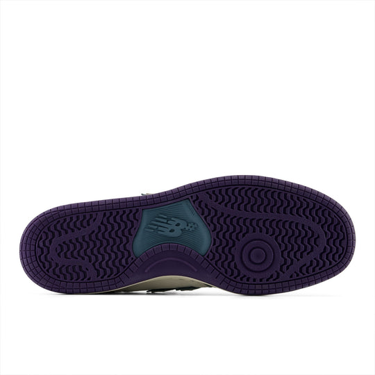 Purple sole of a sneaker with New Balance logo on a white background