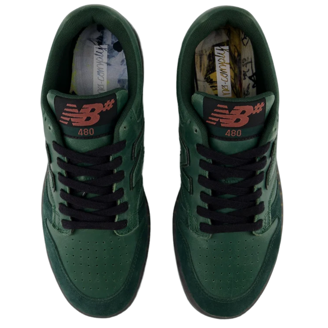 Green sneakers with black laces on a white background