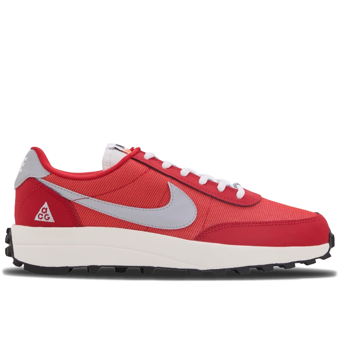 A red Nike Air Max 90 sneaker with a light gray Swoosh, white laces, and a white midsole with a black tread, shown from a side profile on a white background.