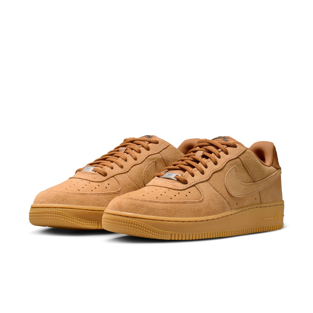 Pair of tan sneakers on a white background