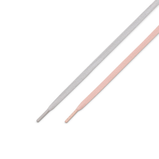 Two flat shoelaces, one light gray and one light pink, shown diagonally on a plain white background.