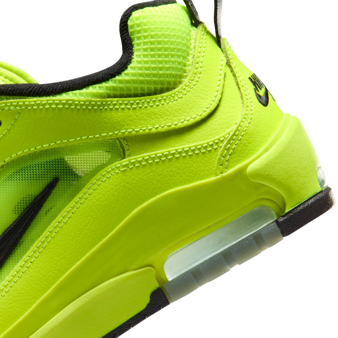 Neon green sneaker with black accents on a white background